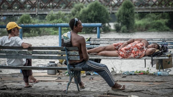 Fumaça densa e escura saindo de um galpão industrial enquanto bombeiros combatem chamas em área urbana no Brás, SP.
