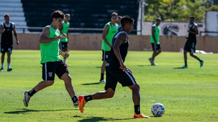 Soccer players in action during a training session on a bright sunny day.