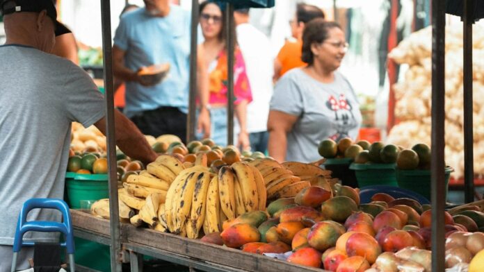 Colorful display of fresh fruits at a bustling market in Espírito Santo, Brazil.