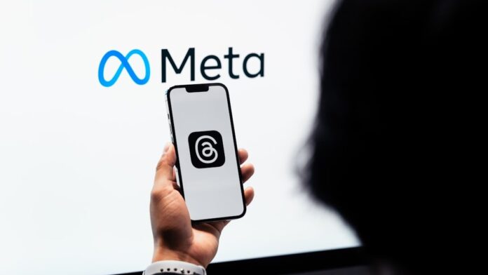 s4-b0a1f934eca8 Young man using new meta threads app on smartphone