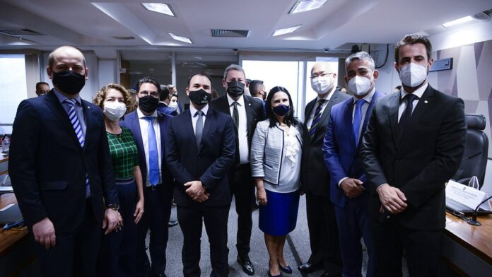 v-nculo-empregat-cio-afastado-em-contratos-religio Pessoas em traje formal assinando documentos em uma mesa de escritório, simbolizando uma formalização contratual.