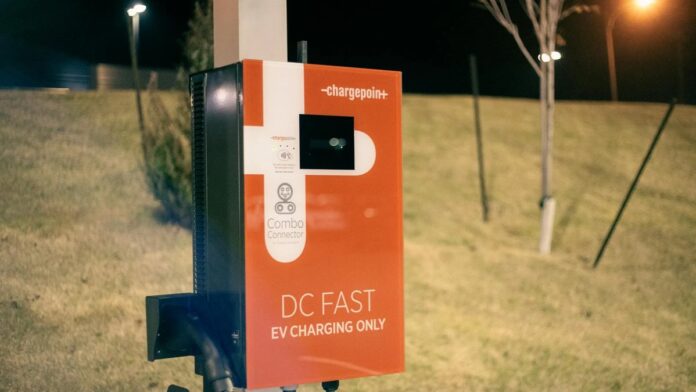 Electric recharging point for vehicles working on eco friendly energy source against hill on roadside at night