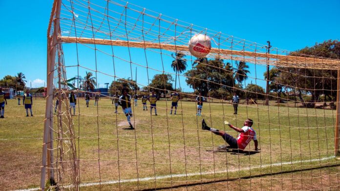 A thrilling moment during a soccer match in Aracaju, Brazil with a goalkeeper missing a challenging save.