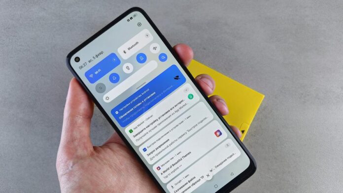 A close-up of a hand holding a smartphone displaying multiple notifications, highlighting modern technology.