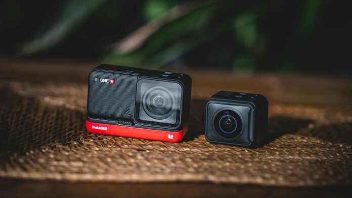 Two modular action cameras resting on a wooden table, ideal for tech enthusiasts and content creators.