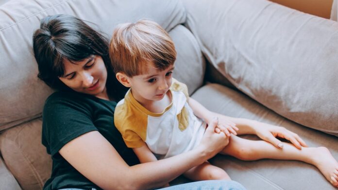 s4-2f0cc698254f a woman and a child sitting on a couch