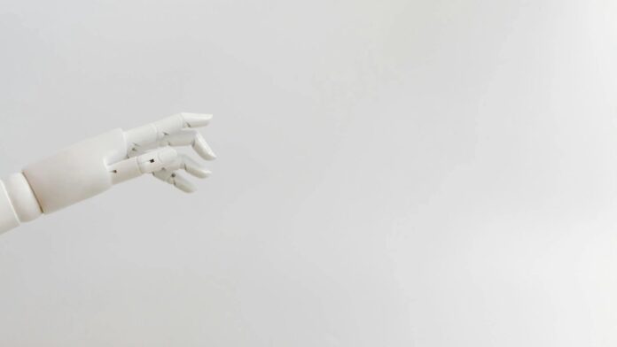 Minimalist image of a robotic hand reaching out on a white background.