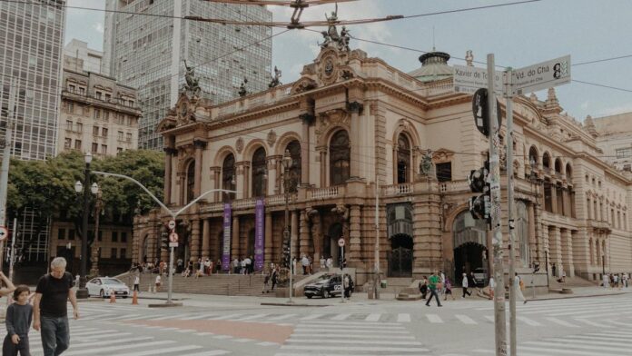 Street view of Municipal Theatre in São Paulo showcasing its historic architecture in a bustling urban setting.