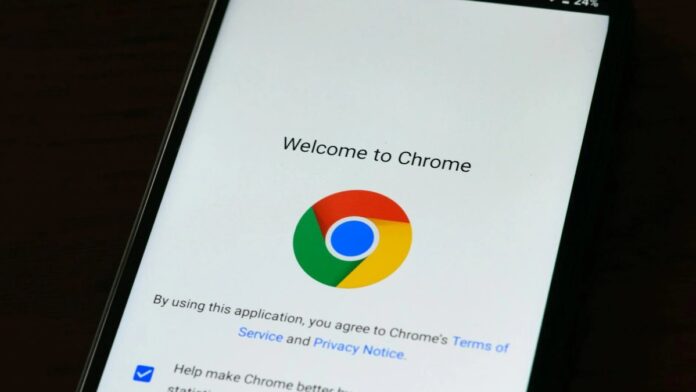 Close-up of smartphone displaying Google Chrome's welcome page and logo.