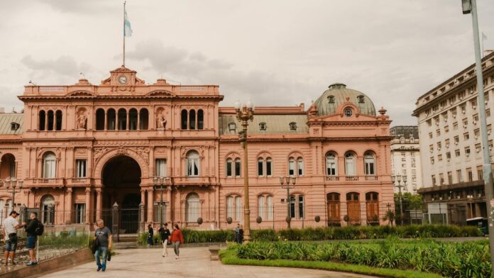 Front view of the historic Casa Rosada in Buenos Aires, Argentina with people in foreground.