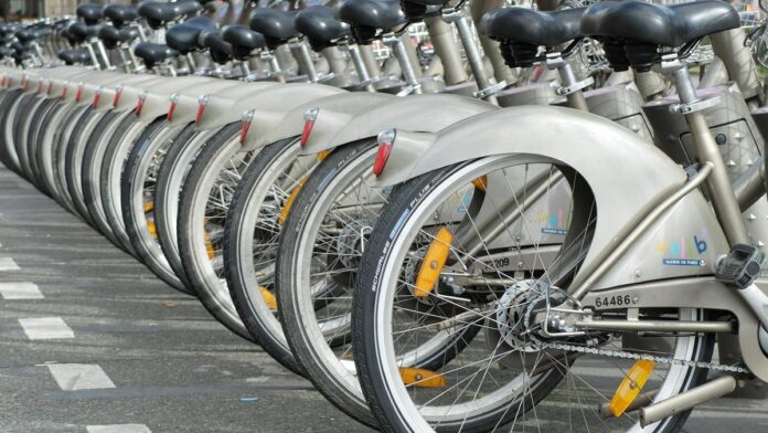 A row of Velib bicycles parked in Paris, highlighting urban cycling culture.