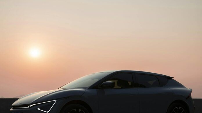 A stylish electric vehicle captured against a serene sunset sky, showcasing modern design and innovation.