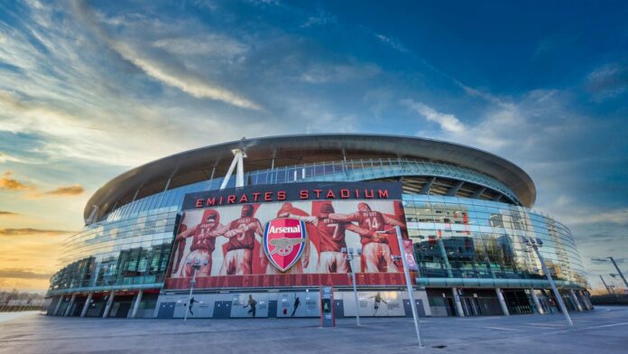 View of Emirates Stadium, home of Arsenal FC in London, showcasing modern architecture under a vibrant sky.