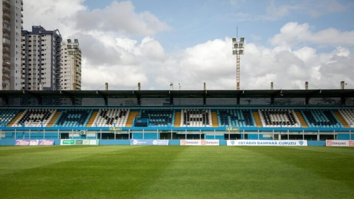 s4-50b25487ca1a-11 Empty Estádio Banpará Curuzu in Belém, Brazil with green grass and clear sky.