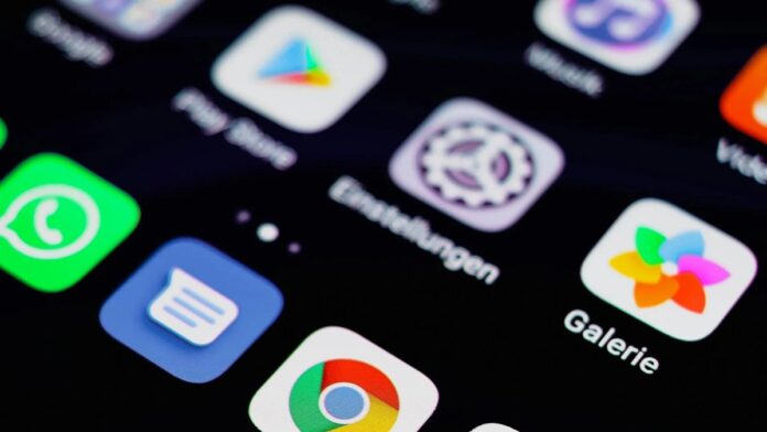 Close-up image of a smartphone screen displaying various app icons on a dark background.