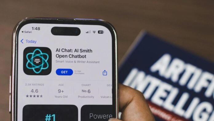 Hand holding a smartphone with AI chatbot app, emphasizing artificial intelligence and technology.