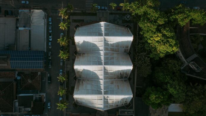 Explore the architectural landscape of Coronel Fabriciano, Brazil, captured from above, showcasing buildings and lush greener