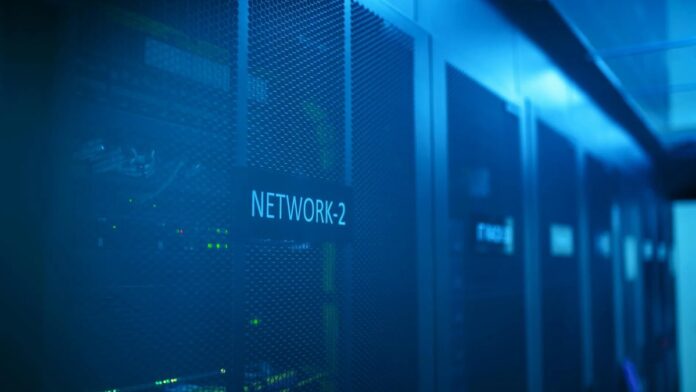 s4-8dee40073f72-1 A modern server room featuring network equipment with blue illumination. Ideal for technology themes.