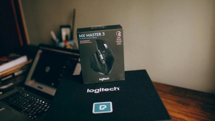 s4-a03d076a789f-3 Image of Logitech MX Master 3 wireless mouse box on a desk with a blurred laptop in background.