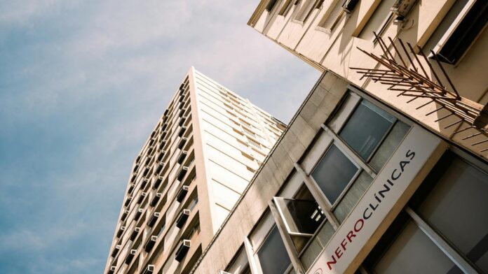 Low angle view of a modern office building in Rio de Janeiro under a blue sky.