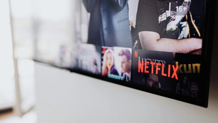 Selective focus of a Netflix screen on a smart TV in an indoor setting.