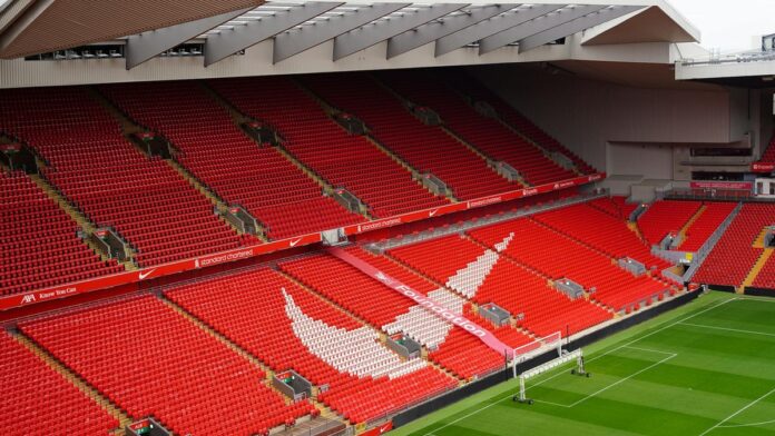 s4-ae93b2097151-2 Aerial view of Anfield Stadium's iconic red seats and pitch, showcasing its architecture and design.