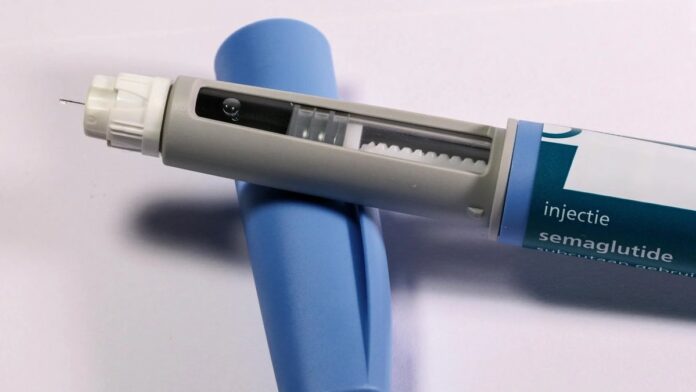 Detailed view of a semaglutide injection pen, commonly used for diabetes treatment, on a plain background.