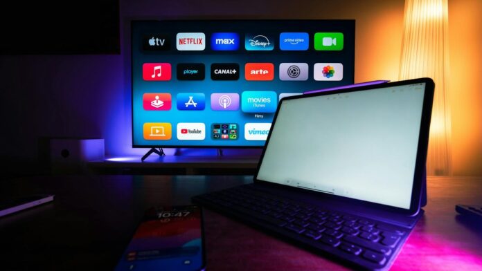 A modern home setup with a smart TV and tablet displaying various streaming apps, highlighting the digital lifestyle.