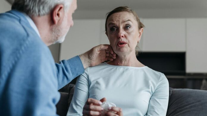 A heartfelt moment between an elderly couple, showcasing emotion and support indoors.
