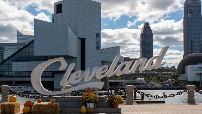 Cleveland sign with modern buildings and autumn decorations