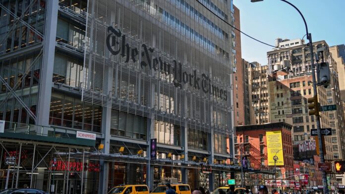 The iconic New York Times building with yellow taxis in bustling Manhattan.