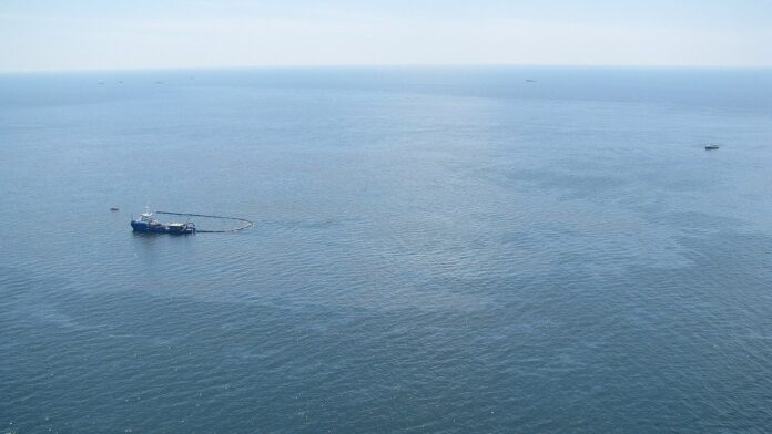 Response boats work to clean up oil where the Deepwater Horizon offshore oil rig sank on April 22, 2010. The mobile drilling
