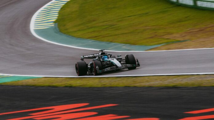 Dynamic shot of a Formula 1 car speeding around the Interlagos circuit in São Paulo.