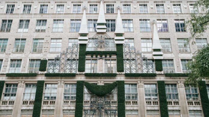 Low angle of modern Sack fifth avenue with ornamental elements and window displays located in New York city on street