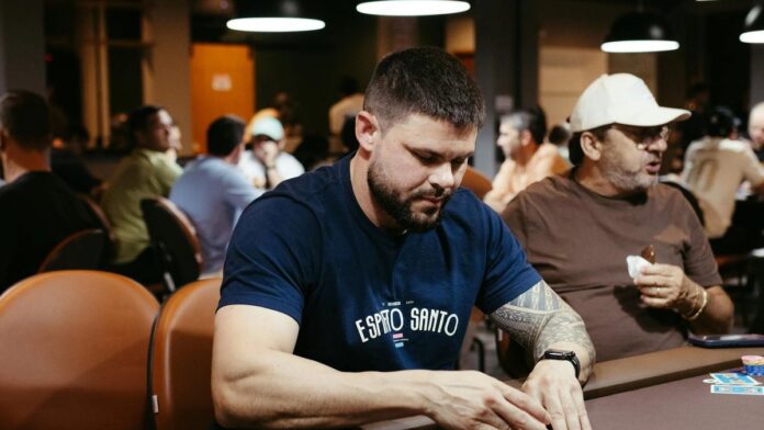 A poker player concentrating during a game in a lively casino atmosphere.