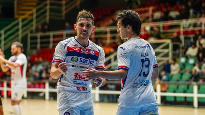 Two soccer players celebrating on the court.