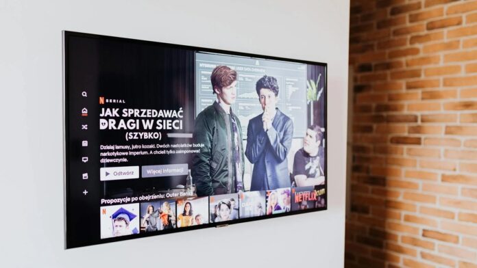 s4-edc764feec78-6 Smart TV displaying streaming content in modern living room setting with exposed brick wall.