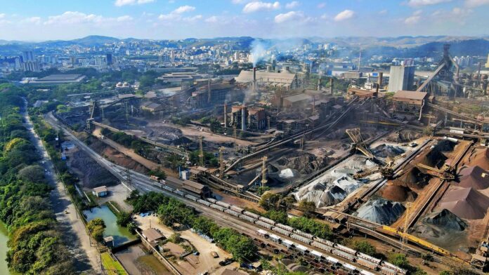 Aerial shot of a bustling industrial area in Rio de Janeiro, Brazil showing factories and cityscape.