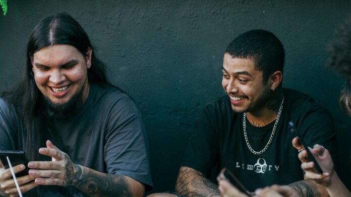 A group of friends having fun outdoors, sharing smiles and enjoying drinks.