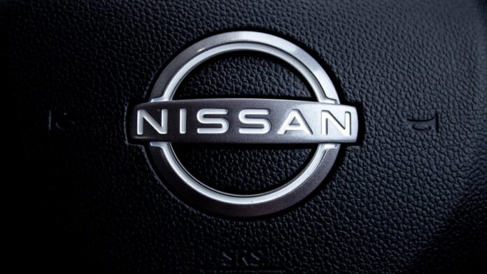 Close-up of a nissan car steering wheel logo.